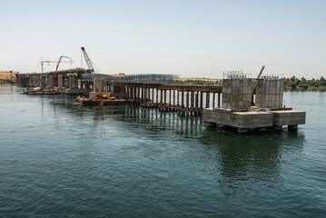 Fototapeta premium Build of new Nile river Bridge after Luxor in direction Assuan during boat cruise construction site
