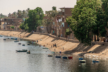 Panoramic view of fertile banks of Nile and everyday life during river cruise River near Luxor...