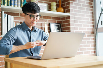 close up asian man make gesture hand about sign language to teaching or talking to colleague in...