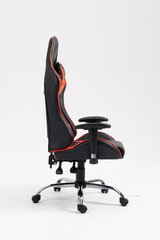 Adjustable red computer gaming chair with footrest isolated on white background. black and red...