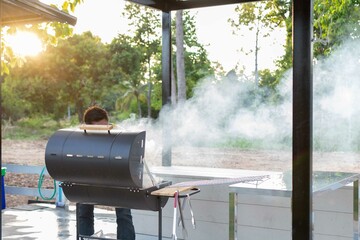 An employee is preparing a fire on the grill to prepare various grills. To serve at barbecue parties