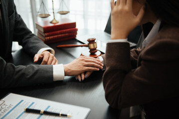 Judge gavel with scales of justice, Business and lawyer or counselor consulting and discussing contract papers with laptop and tablet at law firm