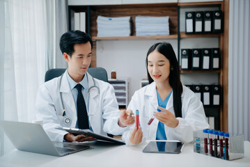 Portrait of Asian doctor speaking to colleagues during medical meeting in conference room or Medical Laboratory.