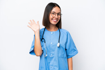 Young surgeon doctor woman isolated on white background saluting with hand with happy expression