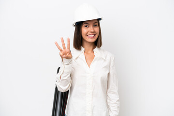 Young architect woman with helmet and holding blueprints isolated on white background happy and counting three with fingers