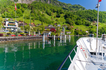 View of Lake Uri with beautiful mountain panorama and Swiss village Bauen on a sunny spring day. Photo taken May 22nd, 2023, Bauen, Switzerland.