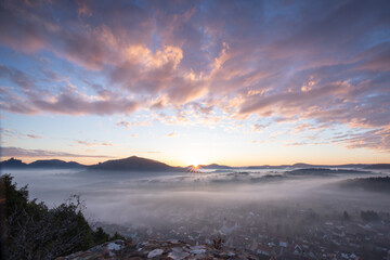 Mystical Sunrise at Wachtfelsen, Palatinate Forest. Captivating landscape shot amidst fog and clouds near Wernersberg, Germany