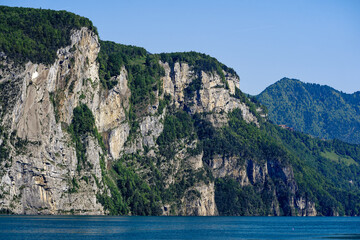 Scenic view of mountain panorama with Lake Lucerne in the foreground on a sunny spring day. Photo taken May 22nd, 2023, Canton Uri, Switzerland.