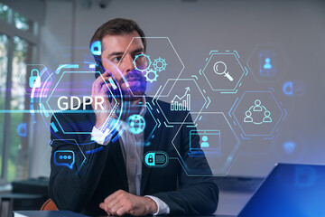 Smiling businessman talking holding using smartphone typing at office workplace with notebook. Concept of distant work, business education. GDPR Icon datum protection