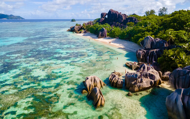 Anse Source d'Argent, La Digue Seychelles, a young couple of men and women on a tropical beach...