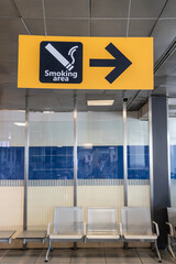 Direction signage to smoking area at airport terminal departure hall