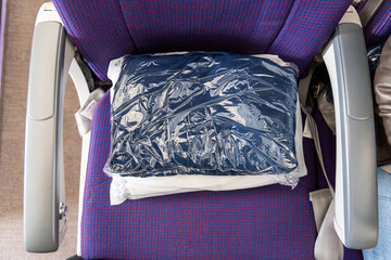 Sanitized and sealed wool blanket in plastic bag provided to passengers to keep warm and comfortable during flight