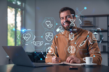 Thoughtful businessman in casual wear typing on laptop at office workplace. Concept of insurance company, help, business, internet surfing, information technology. Medical icons hologram