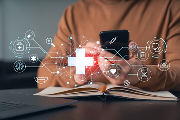 Man reading, text and send messages, holding using smartphone typing at office workplace with notebook. Concept of distant work, business education. Buy medical healthcare insurance