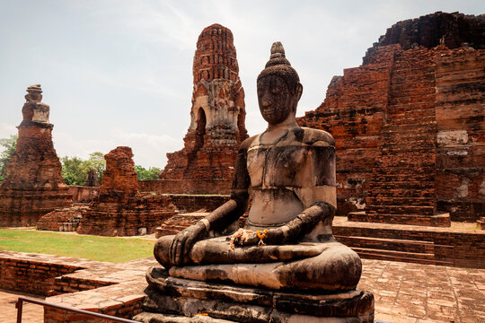 Buddha statue in temple complex at Wat Mahathat in Ayutthaya. Ayutthaya is ancient ruined capital of kingdom Siam.