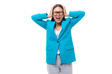 young slender emotionally upset brunette model in a stylish blue designer jacket. office fashion concept