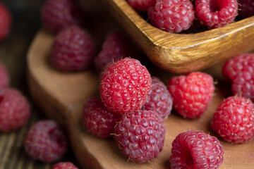 Ripe raspberries on a wooden board