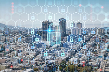 Panoramic cityscape view of San Francisco financial downtown at day time from rooftop, California, United States. The concept of cyber security to protect confidential information, padlock hologram