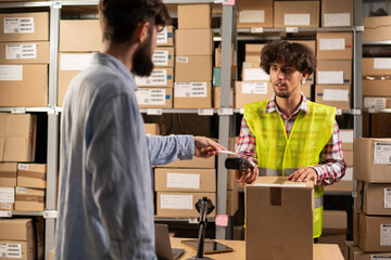 Male customer payment online order at pick-up point. Online store warehouse arabic worker giving parcel to man client at post office © Andrii Lysenko