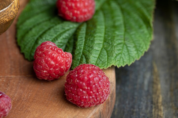 Ripe raspberries on a wooden board