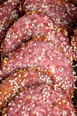Sliced sausage with spices and lots of sesame seeds