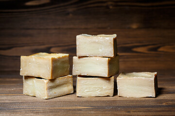 Bars of traditional aleppo natural laurel soap on a wooden background.