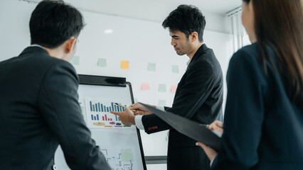 Group of Young Asian business team creative businesspeople coworker in office. Meeting Presentation for analysis graph company financial. People Work in Business Office.