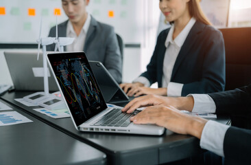 Businessman team brainstorming using tablet, laptop computer for working technology and business,  Renewable energy-based green businesses and global warming. Reduce CO2 emission.