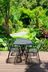 Black metal table and chairs in garden