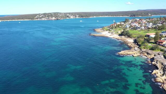 Aerial drone view of Cronulla South along Oak Park Beach and Rock Pool in the Sutherland Shire, South Sydney, NSW Australia looking south over Port Hacking on a sunny day in July 2023  
