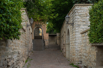 An arched stone passage at the end of a medieval narrow street in Old Town, Tallinn, Estonia.