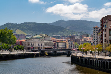 Fototapeta na wymiar Promenade area of the River Nervion. In background the old city of Bilbao in front plane the river Nervion. Travel destination in North of Spain, Basque Country