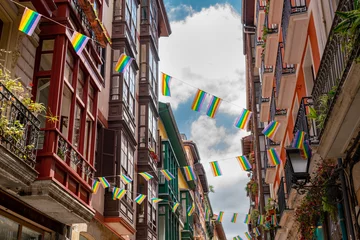 Photo sur Plexiglas Vieil immeuble Beautiful streets of European city Bilbao. Situated in North of Span is the largest city in Basque Country and important travel destination. View of historic center. Street decorated with LGBT flag