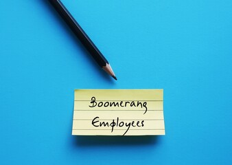 Pencil wrote on yellow note on blue background - Boomerang Employees - workers returning to a...