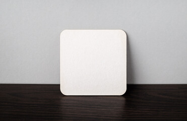 Photo of blank white square beer coaster.