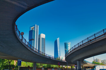 Elevated road with the skyscrapers of the Cuatro Torres Business area in Madrid in the background.