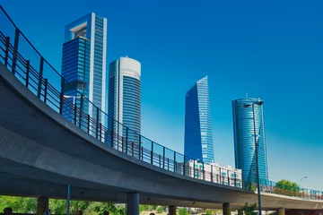 Poster Elevated road with the skyscrapers of the Cuatro Torres Business area in Madrid in the background © LuisM