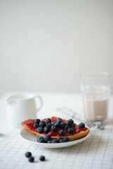 Fresh delicious breakfast with Coffee, crispy croissants, jam on white wooden background. Selective focus. Romantic french weekend concept.