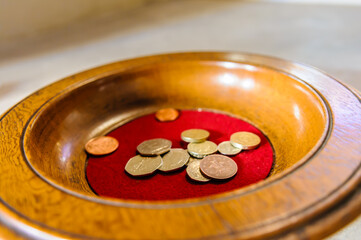 Church collection bowl with some UK Coins