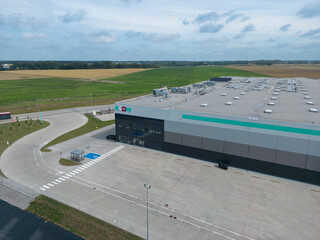 aerial drone view of  warehouse building with bays and trucks

