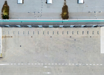 aerial drone view of  warehouse building with bays and trucks

