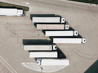 aerial drone view of parking with trucks and trailers 