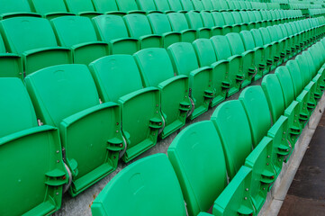 Empty green tiered seats in a stadium