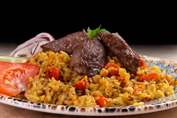 Traditional dish pilaf. On a brown background.