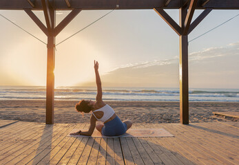person watching the sun on the beach doing exercise and yoga on beach