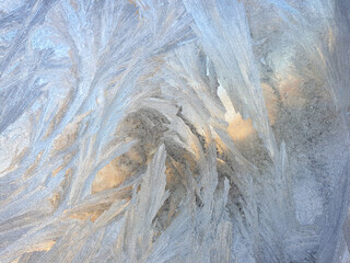 frosty patterns on the window glass closeup. natural textures and backgrounds. ice patterns on frozen
