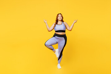 Fototapeta na wymiar Full body young chubby plus size big fat fit woman wear blue top warm up train raise up hands leg in yoga om gesture meditate isolated on plain yellow background studio home gym Workout sport concept