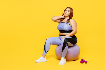Full body young chubby plus size big fat fit woman wear blue top warm up training sit on fit ball...