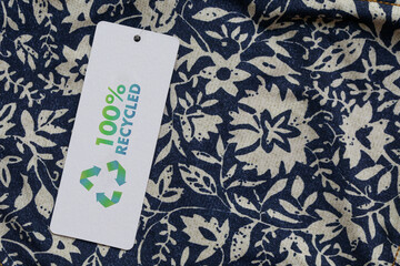 Close up of clothing tag with recycle icon. Recycling products concept. Zero waste, suistainale production, environment care and reuse concept