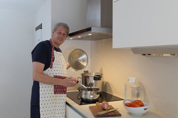cook in the kitchen, man cooking with giant pot and a smaller one